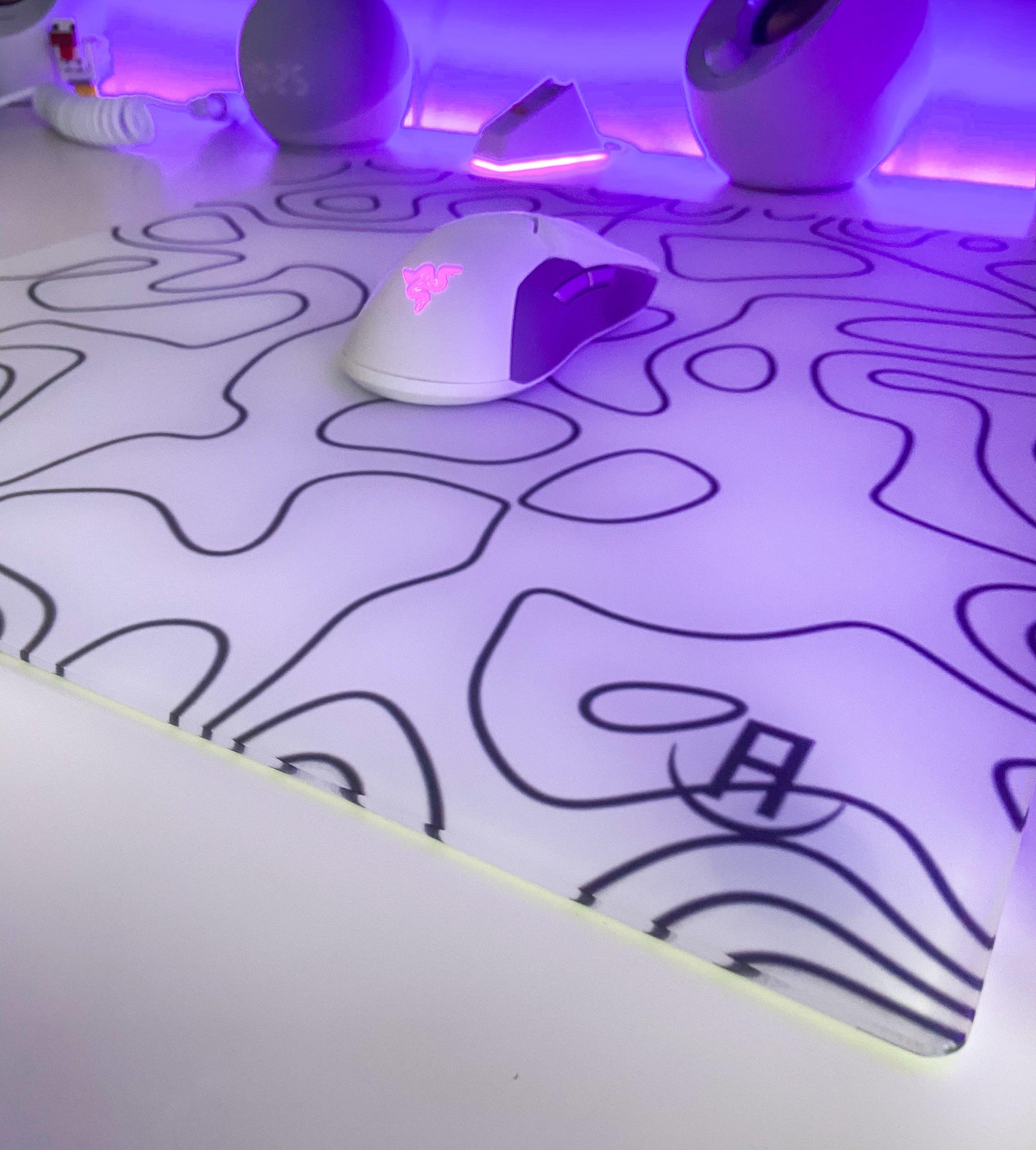 white topography glass mousepad on desk in gaming setup