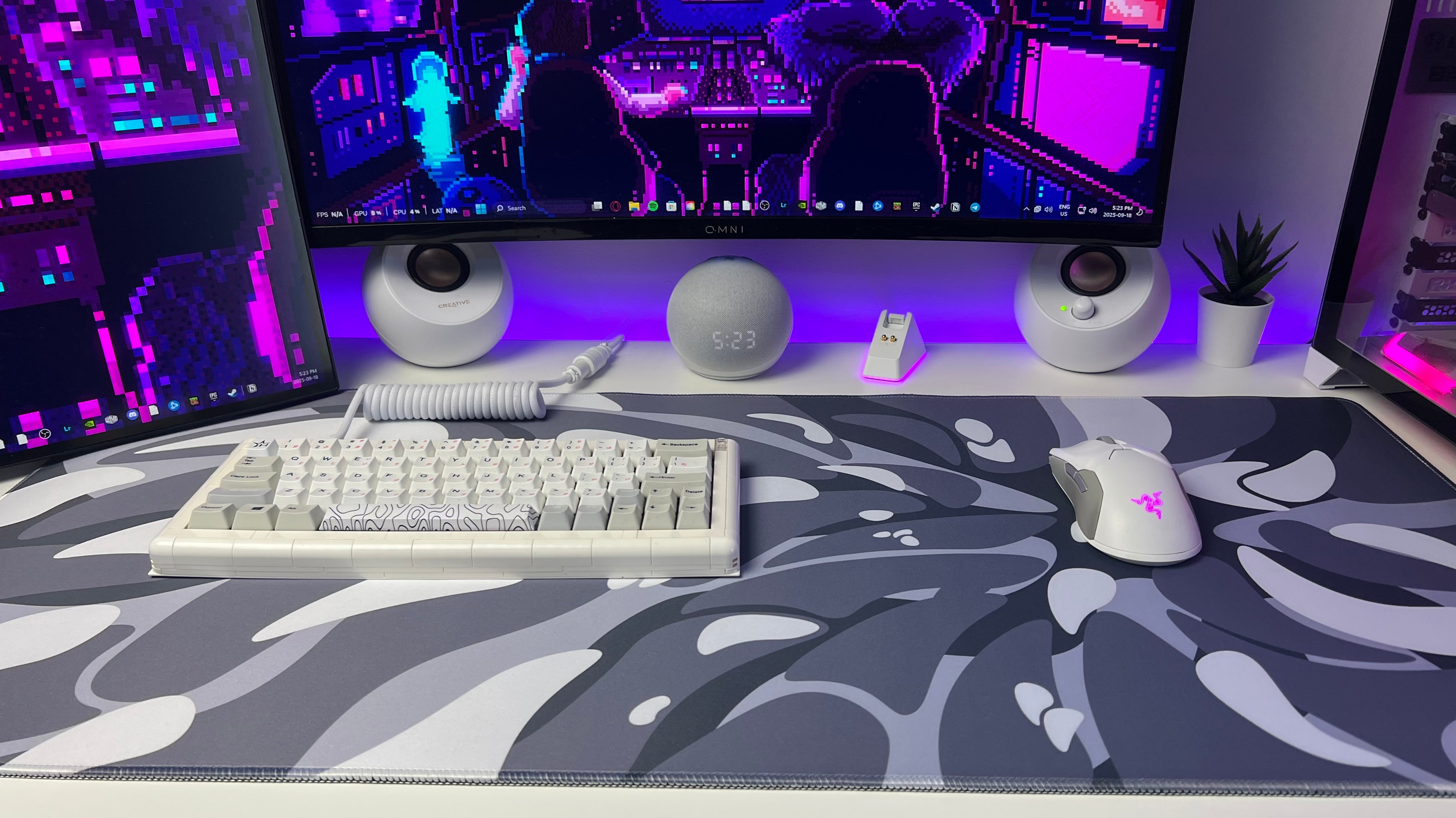 front view of gaming setup with black and white liquefied V2 desk pad with gaming keyboard and gaming mouse on the water proof mousepad