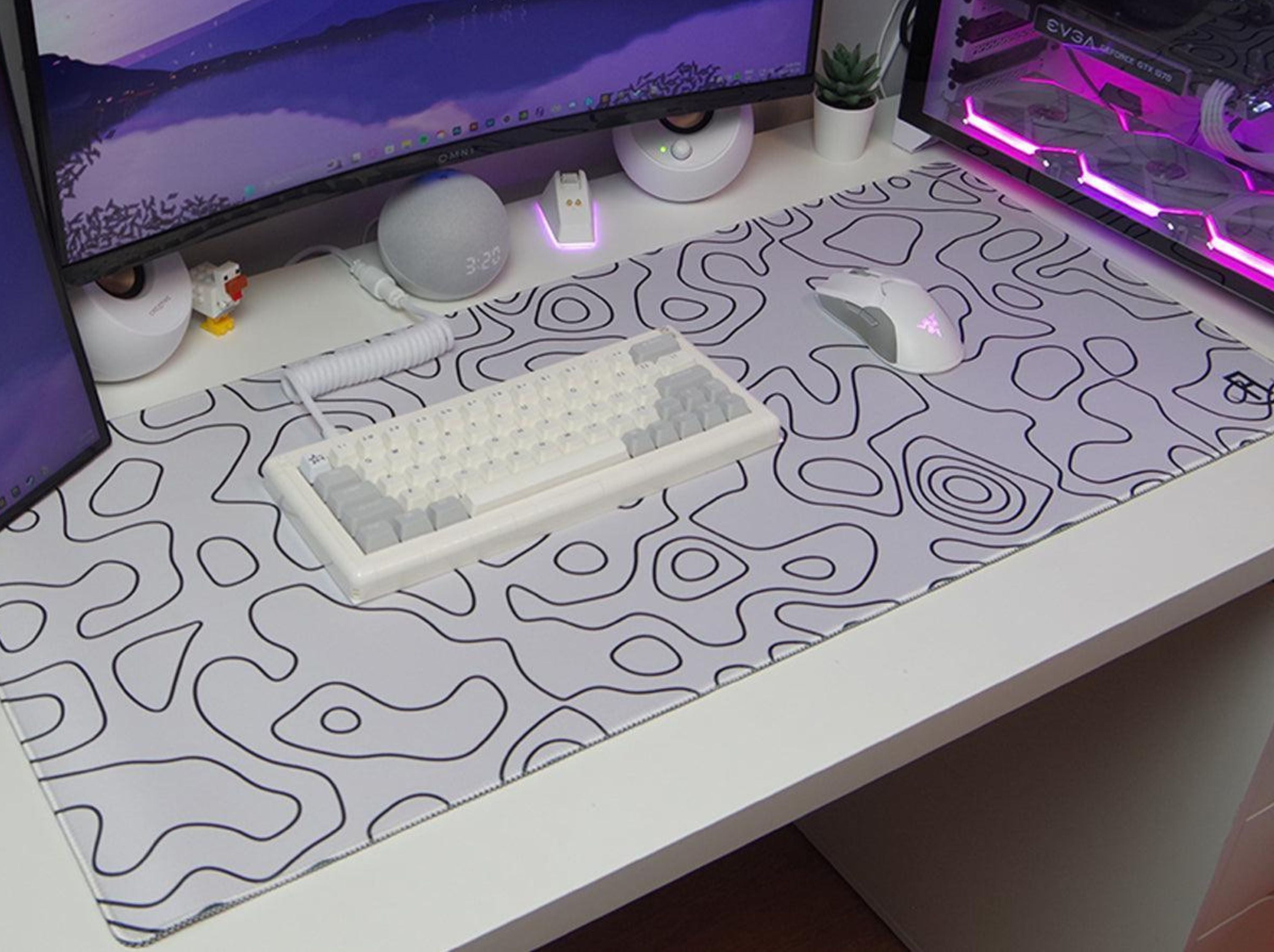 white topography gaming mouse pad on a desk in a gaming setup